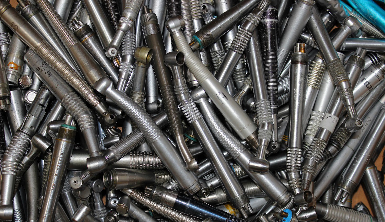 Pile of dental handpieces for repair