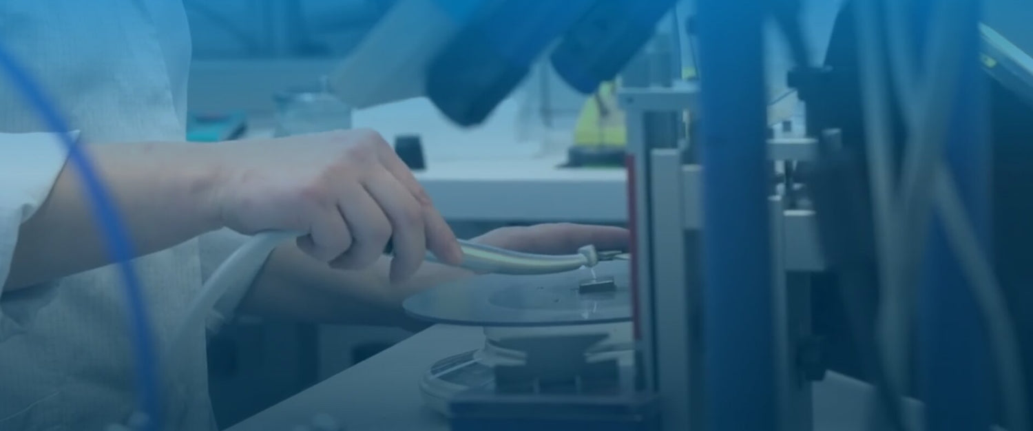 Person testing dental handpiece repair in a laboratory setting